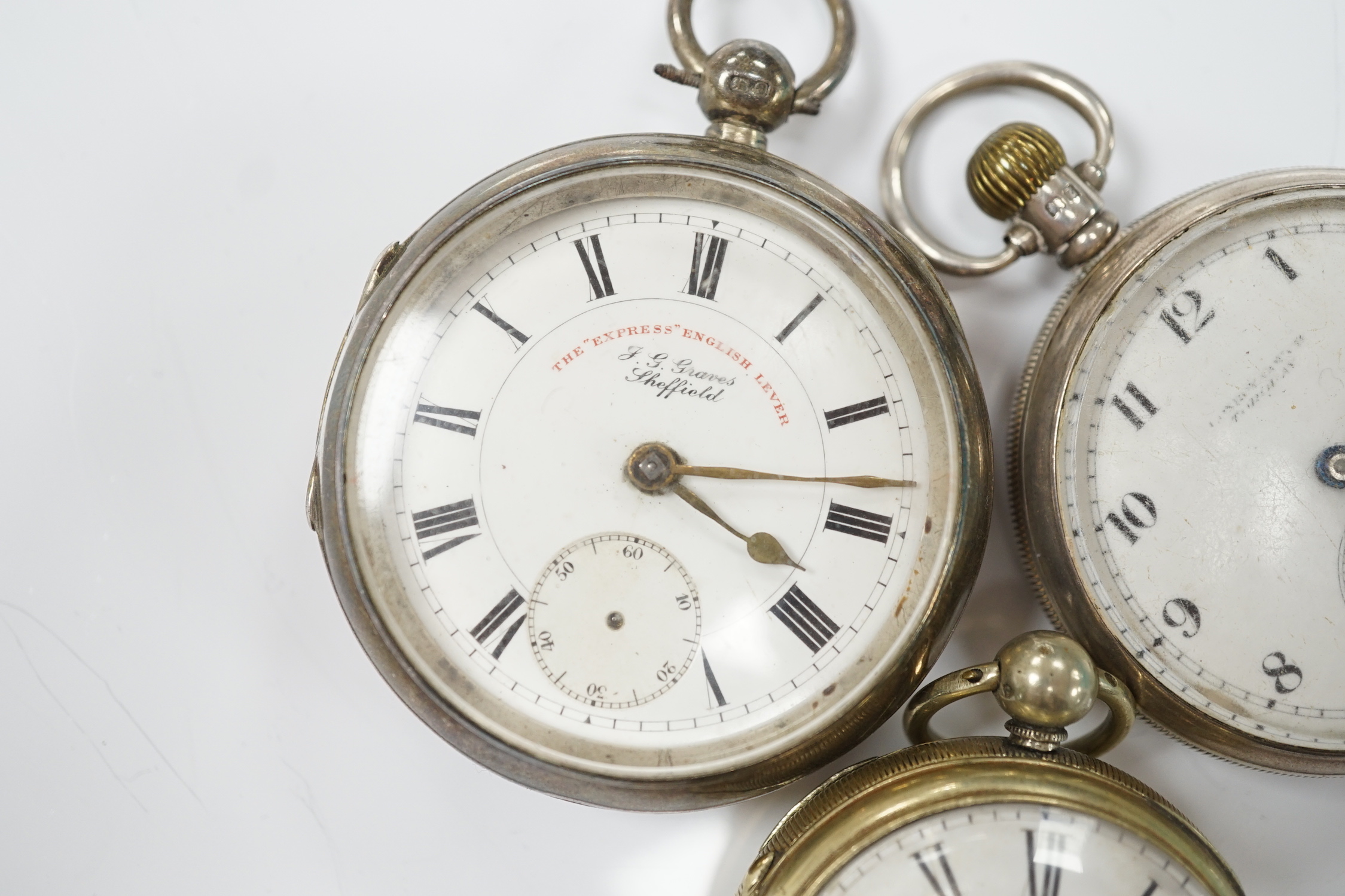 A Georgian gilt metal pair cased pocket watch (lacking outer case) by Masters of Piccadilly, with Roman dial, together with two early 20th century silver open face pocket watches including 'Express English Lever'.